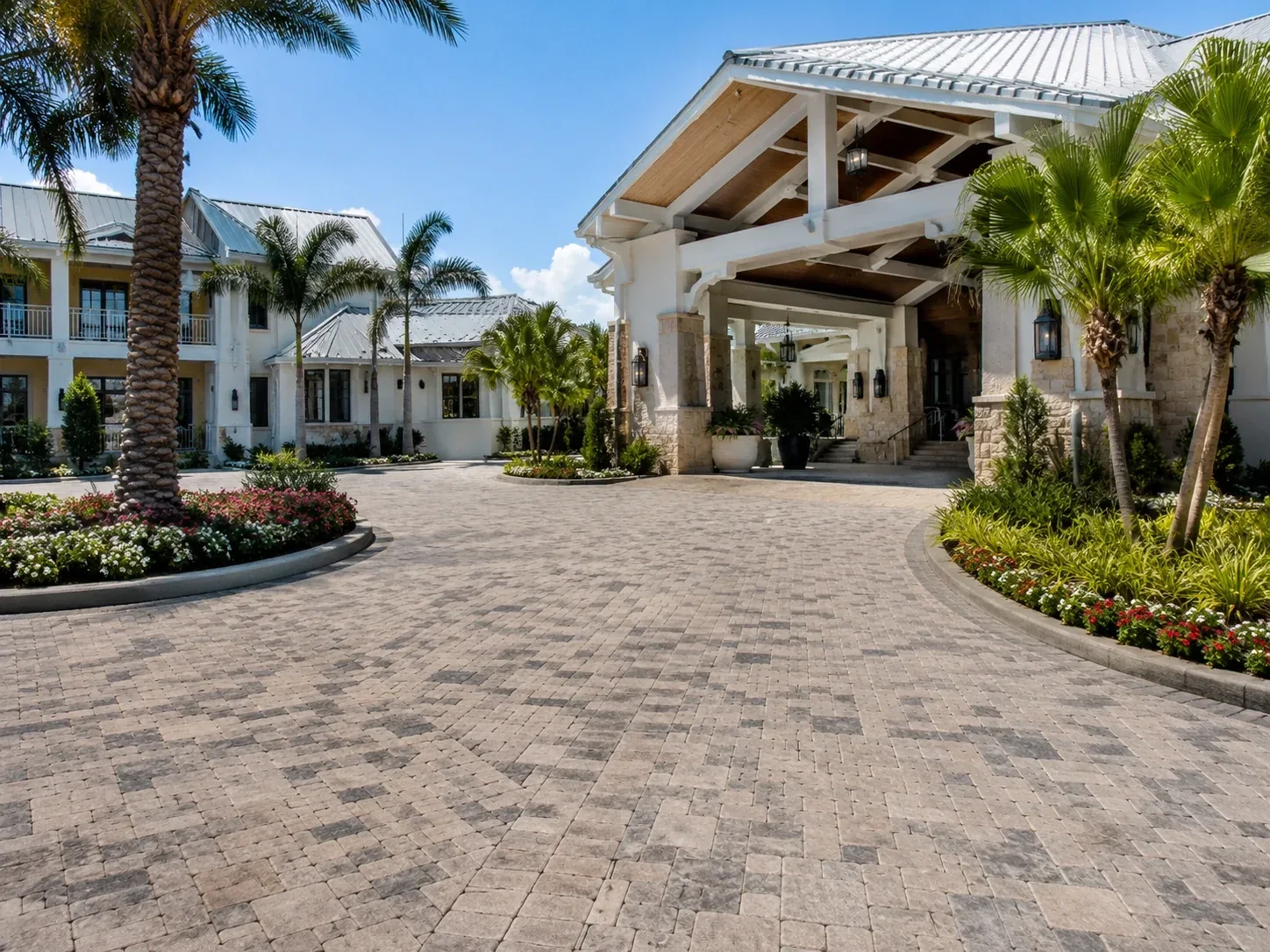 Luxury Florida hotel entrance with a wide brick paver arrival drive